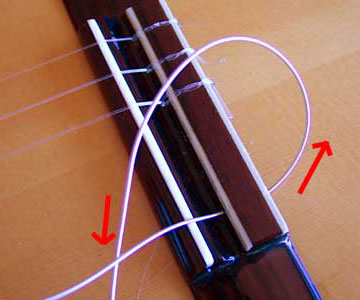 string restring guitar end tie classical knots through classic arrow restringing under direction feed pass take re